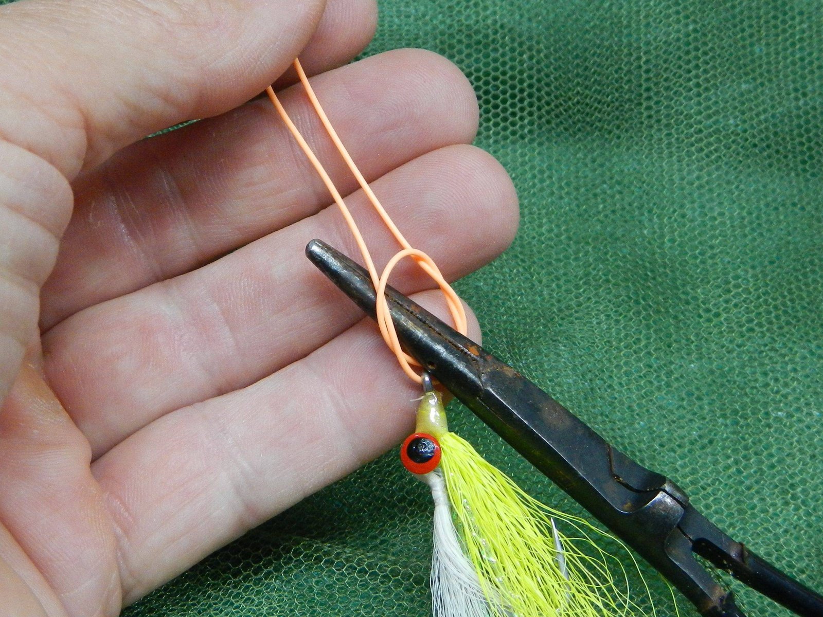 Step 3 Insert the forceps into the overhand knot